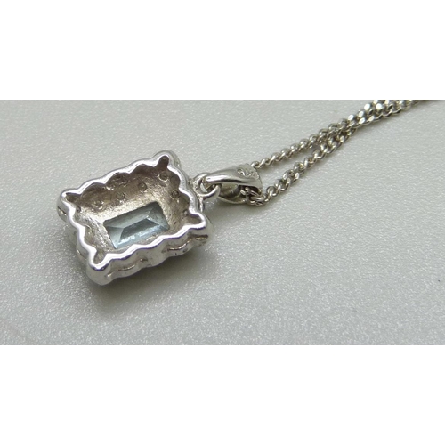 997 - A 9ct gold and aquamarine pendant with diamond accents and a 9ct gold chain, total weight 3.4g