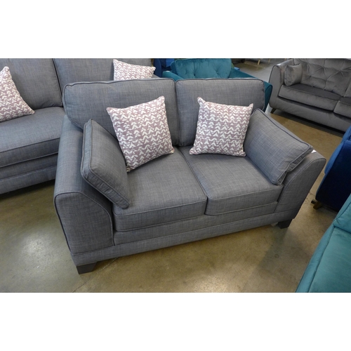 1301 - A pair of dark grey upholstered three seater sofas and a matching two seater sofa