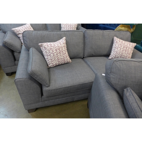 1301 - A pair of dark grey upholstered three seater sofas and a matching two seater sofa