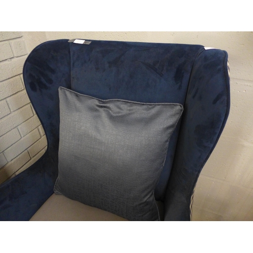 1323 - A blue velvet wingback armchair