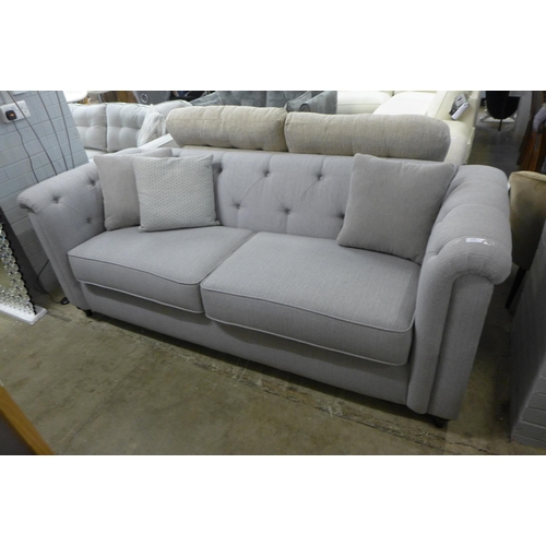 1383 - A grey upholstered buttoned three seater sofa