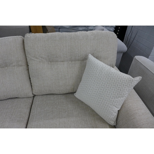 1446 - An oatmeal upholstered three seater sofa