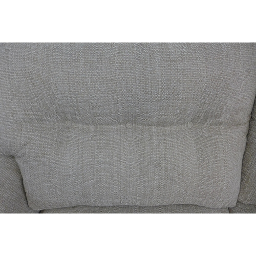 1446 - An oatmeal upholstered three seater sofa