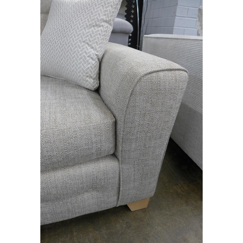 1446 - An oatmeal upholstered three seater sofa