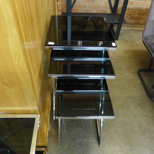 1520 - A chrome and black glass nest of three tables