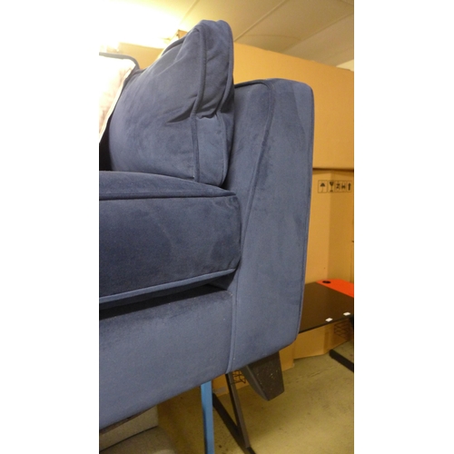 1562 - A blue velvet two seater sofa - damaged frame