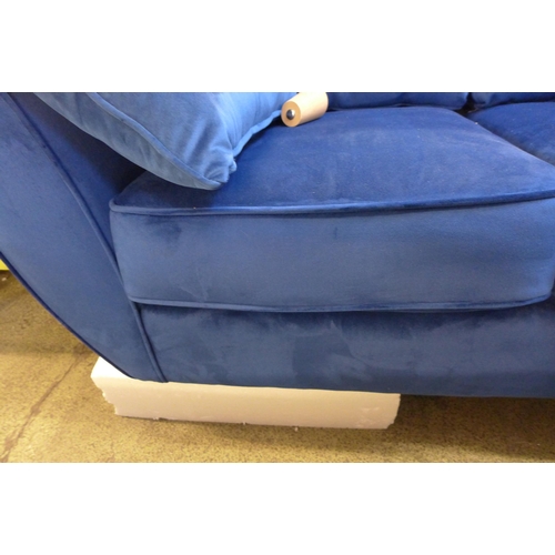 1572 - A Hoxton blue velvet two seater sofa - damaged leg