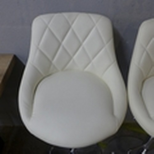 1455A - A pair of Aldin cream upholstered diamond stitching gas lift bar stools, boxed