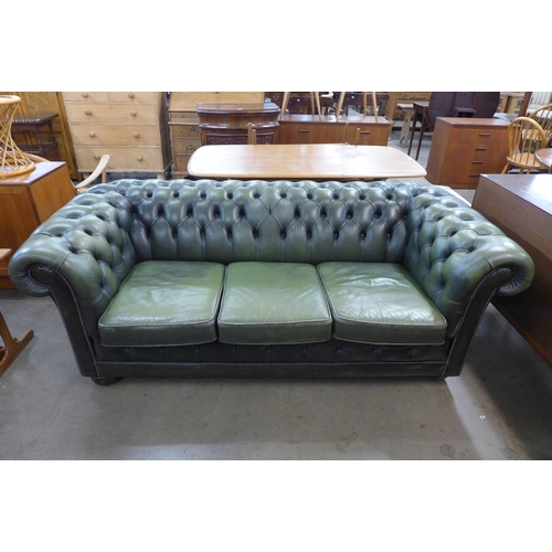 91 - A green leather Chesterfield settee