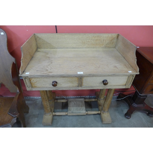 101 - A Victorian Gothic Revival light oak two drawer wash stand