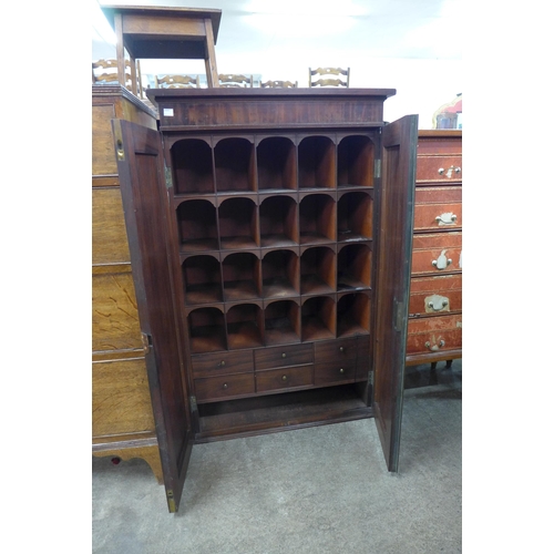 121 - A George IV mahogany fitted two door pigeon hole cabinet