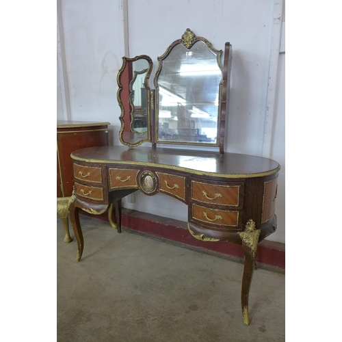 133 - A French mahogany and parcel gilt kidney shaped dressing table