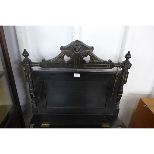 135 - A Victorian Aesthetic Movement ebonised and parcel gilt music stand