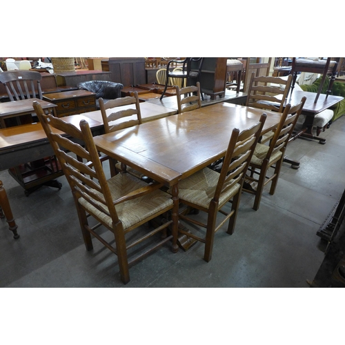 142 - An 18th Century style oak refectory table and six chairs