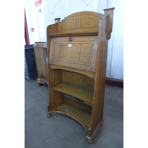 143 - An Arts and Crafts inlaid oak student's bureau