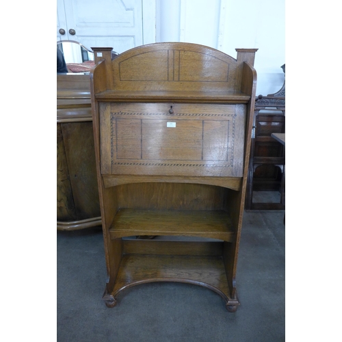 143 - An Arts and Crafts inlaid oak student's bureau