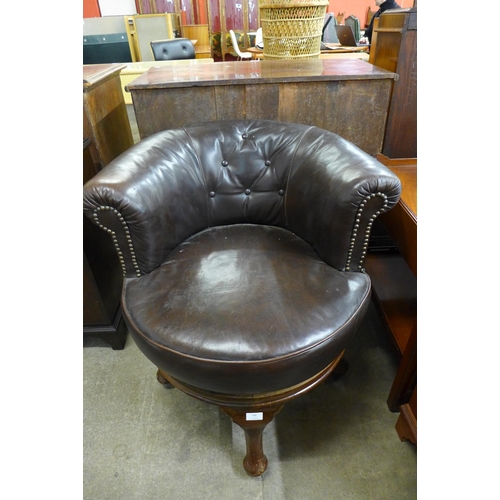 148 - A Victorian mahogany and brown leather revolving desk chair