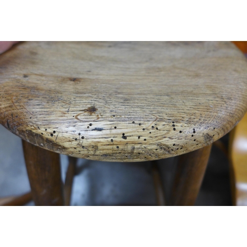 152 - A pair of early 20th Century oak kitchen stools and another