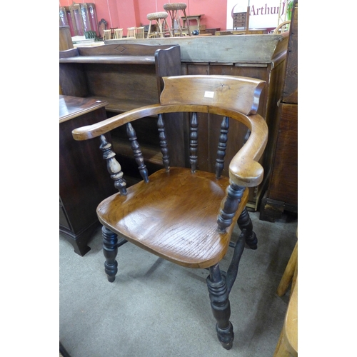 164 - A Victorian elm and beech smokers bow chair