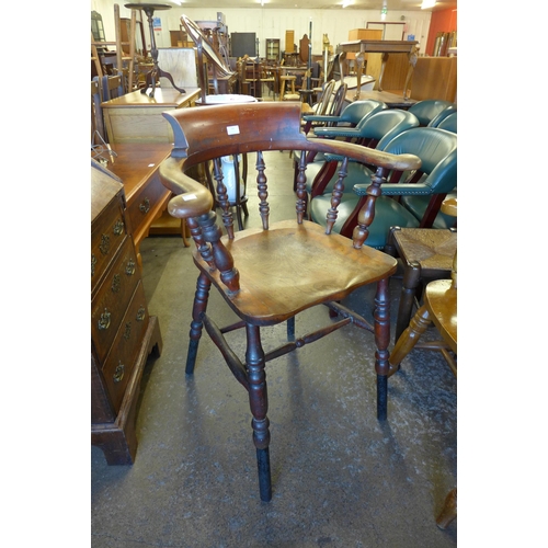 184 - A Victorian elm and beech raised smokers bow chair