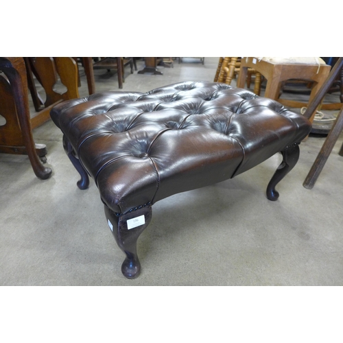 196 - A chestnut brown leather Chesterfield footstool