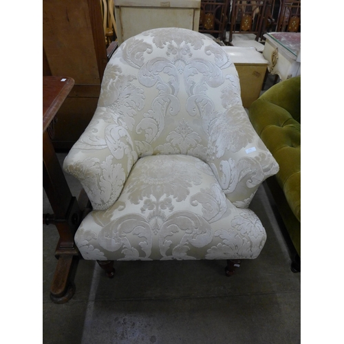 224 - A Victorian style beech and fabric upholstered armchair