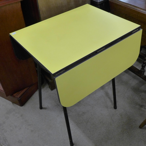 228 - A pair of teak and yellow Formica topped occasional tables, a steel and Formica topped drop-leaf kit... 