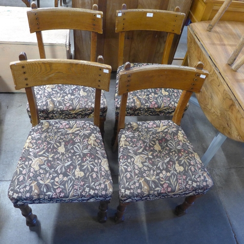 236 - A set of four Victorian Gothic Revival elm dining chairs