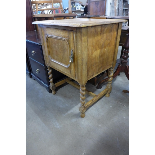 254 - An oak barleytwist pot cupboard