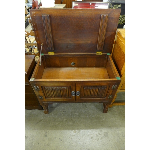 259 - A carved oak linenfold two door cupboard