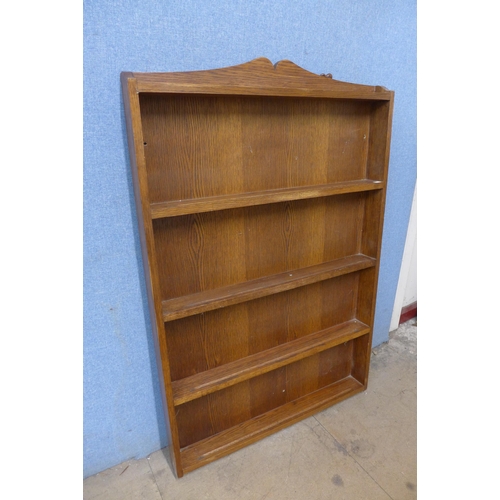 266 - An oak open bookcase, with carved otter to top