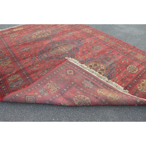 266E - An eastern red ground rug, 377 x 275cms and one other, 347 x 237cms