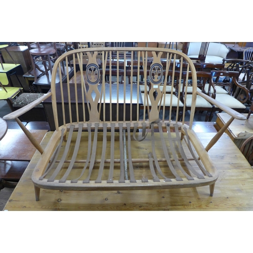 280 - An Ercol beech fleur de lys settee