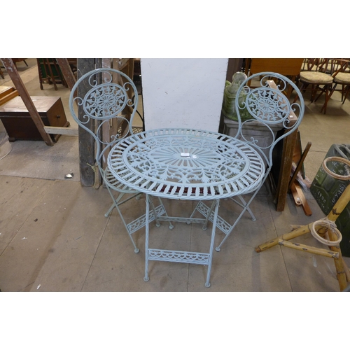 313 - A painted wrought iron folding garden table and two chairs