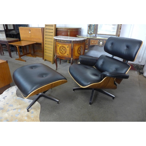 59 - A Charles & Ray Eames style simulated rosewood and black vinyl revolving lounge chair and stool