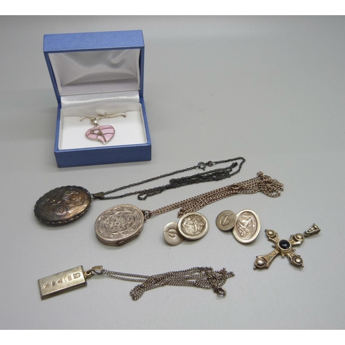 1016 - A silver locket, one other locket, a pair of silver cufflinks, a cross pendant and two pendants on c... 