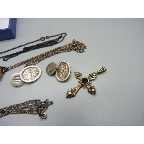 1016 - A silver locket, one other locket, a pair of silver cufflinks, a cross pendant and two pendants on c... 