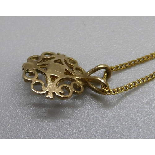 1057 - A fine 9ct gold chain, 1.3g, and a yellow metal pendant