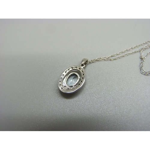 1059 - A 9ct white gold, aquamarine and diamond pendant and chain, 1.6g