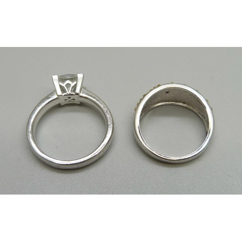 1078 - A silver ring set with a small yellow diamond and a silver ring set with large white stone