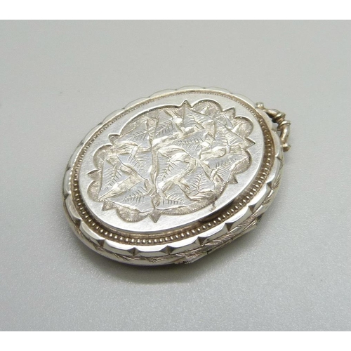 1084 - A Victorian white metal locket, lacking loop, 20g, 33mm wide