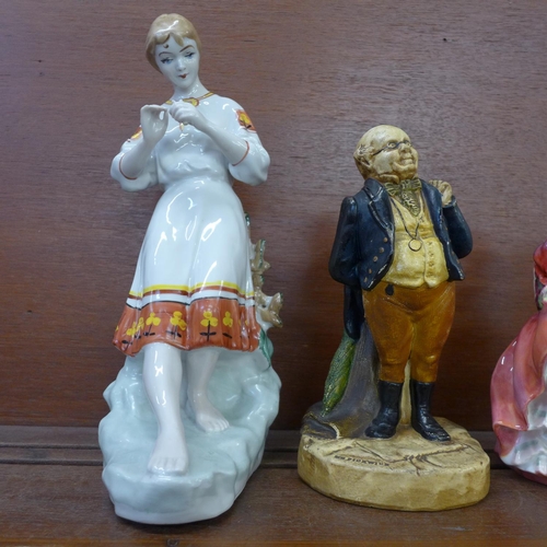 601 - A Bretby figure, Mr Pickwick, a 1930's Royal Doulton figure, Top o' the Hill, a Wedgwood & Co. cream... 