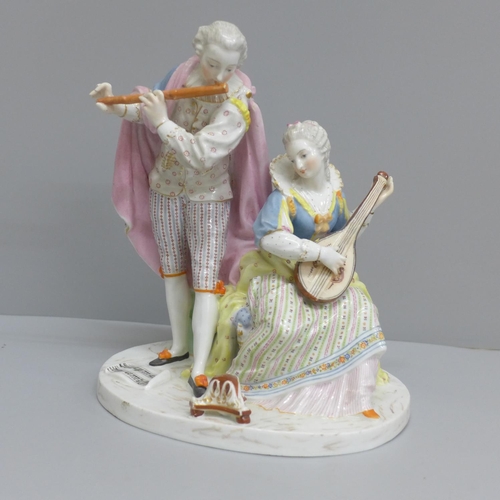 606 - A Dresden porcelain figure of two musicians, 21.5cm