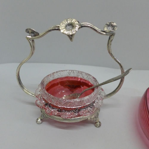 631 - A cranberry glass heart shaped dish and a cranberry glass preserve pot, stand and spoon (2)