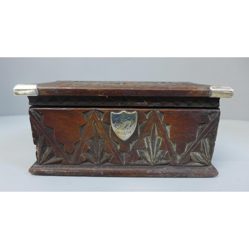 653 - A carved wooden box with white metal corner trims and a 19th Century sliding box