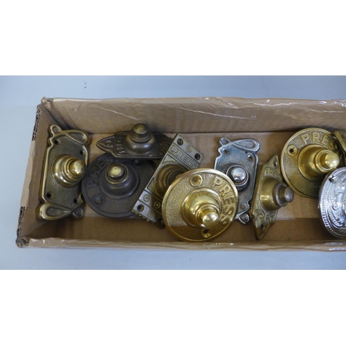 688 - A collection of twelve brass door bell pushers