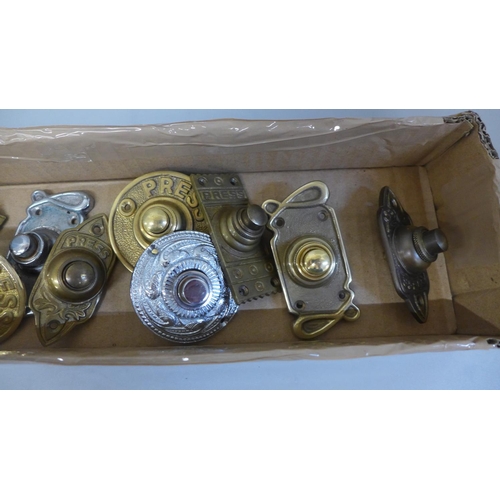 688 - A collection of twelve brass door bell pushers