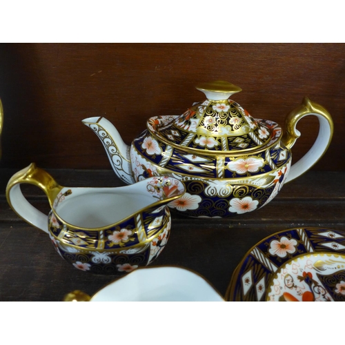 697 - A Royal Crown Derby 2451 four setting tea set with tea pot, cream and sugar bowl