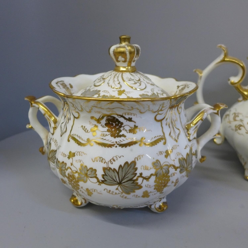 699 - A Rockingham porcelain tea pot, a similar lidded sugar bowl and one other