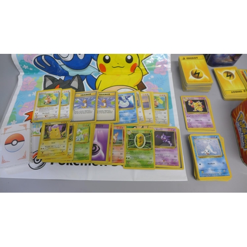 761 - 700 Pokemon base set cards including collector tins and book, etc.